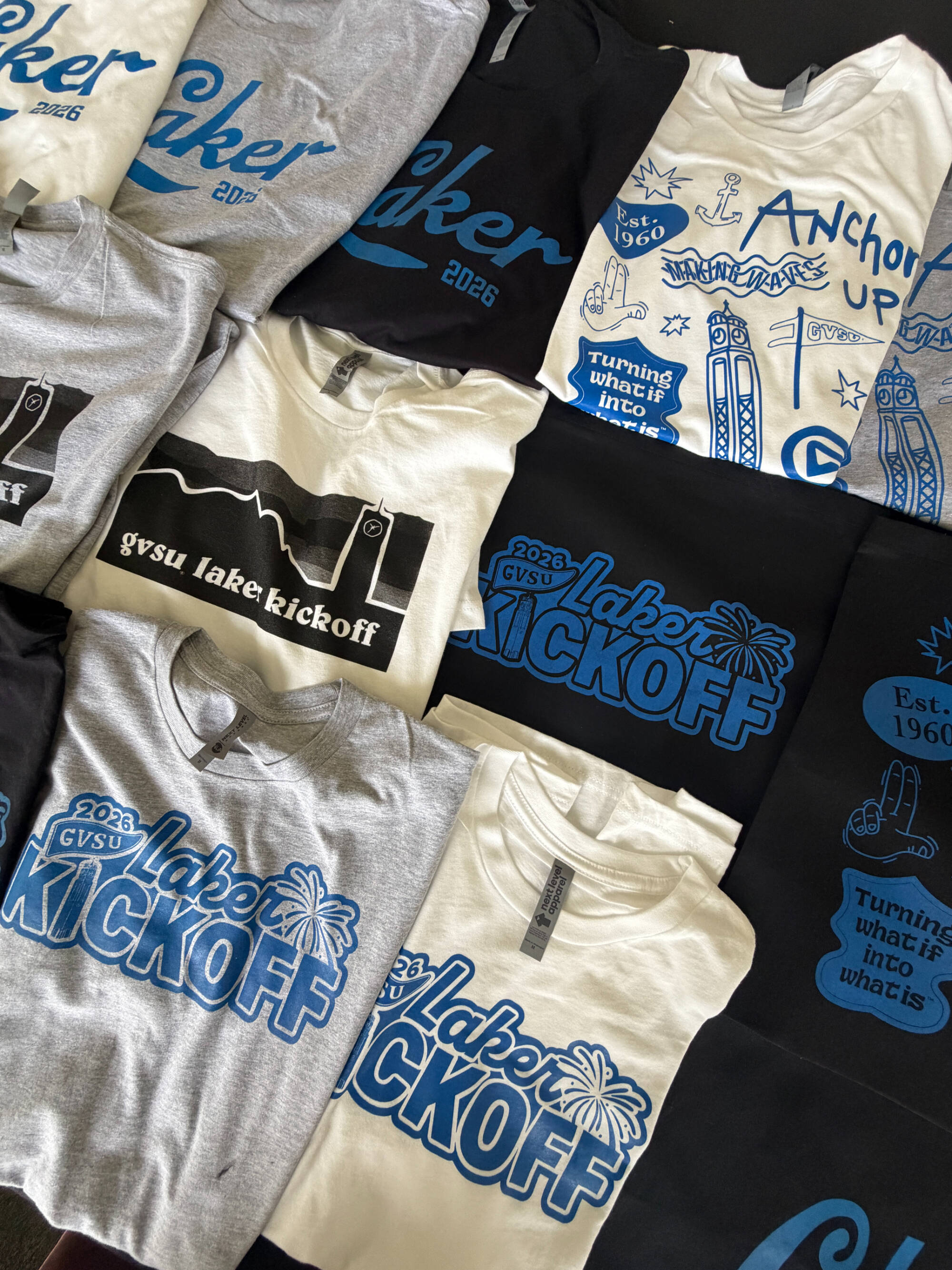 a variety of grey, white, and black GVSU t shirts that say Laker Kickoff on them